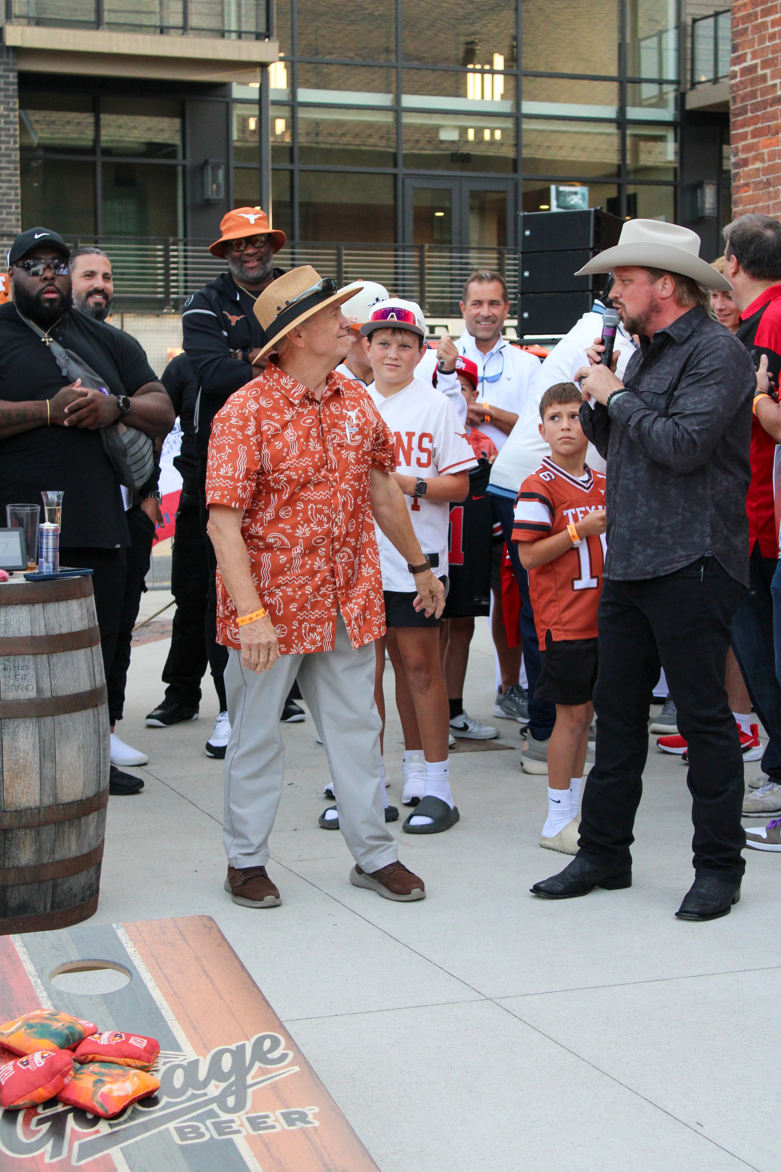Fans and athletes at outdoor event with Texas Longhorns branding