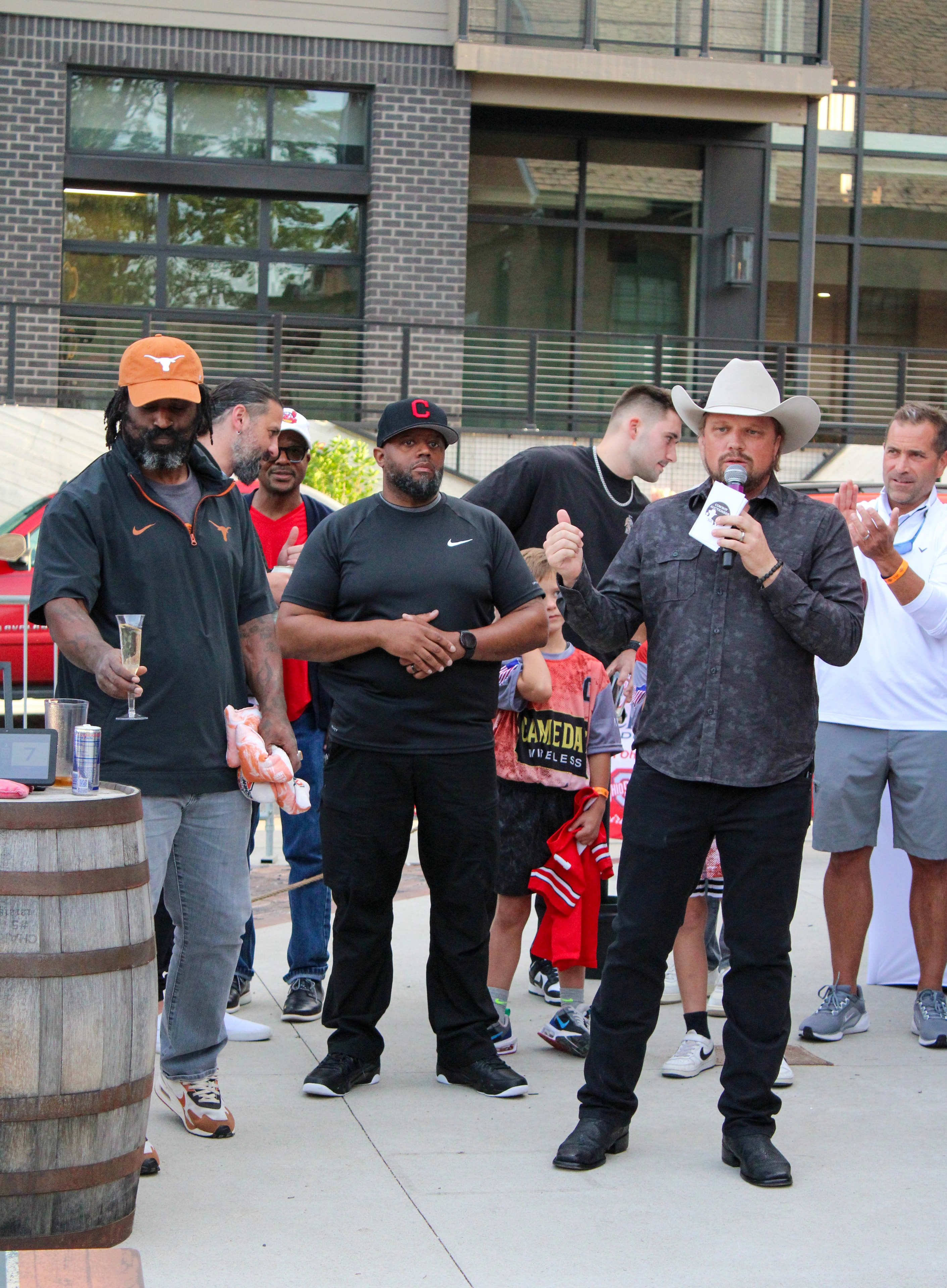 Athletes and fans at outdoor cornhole event